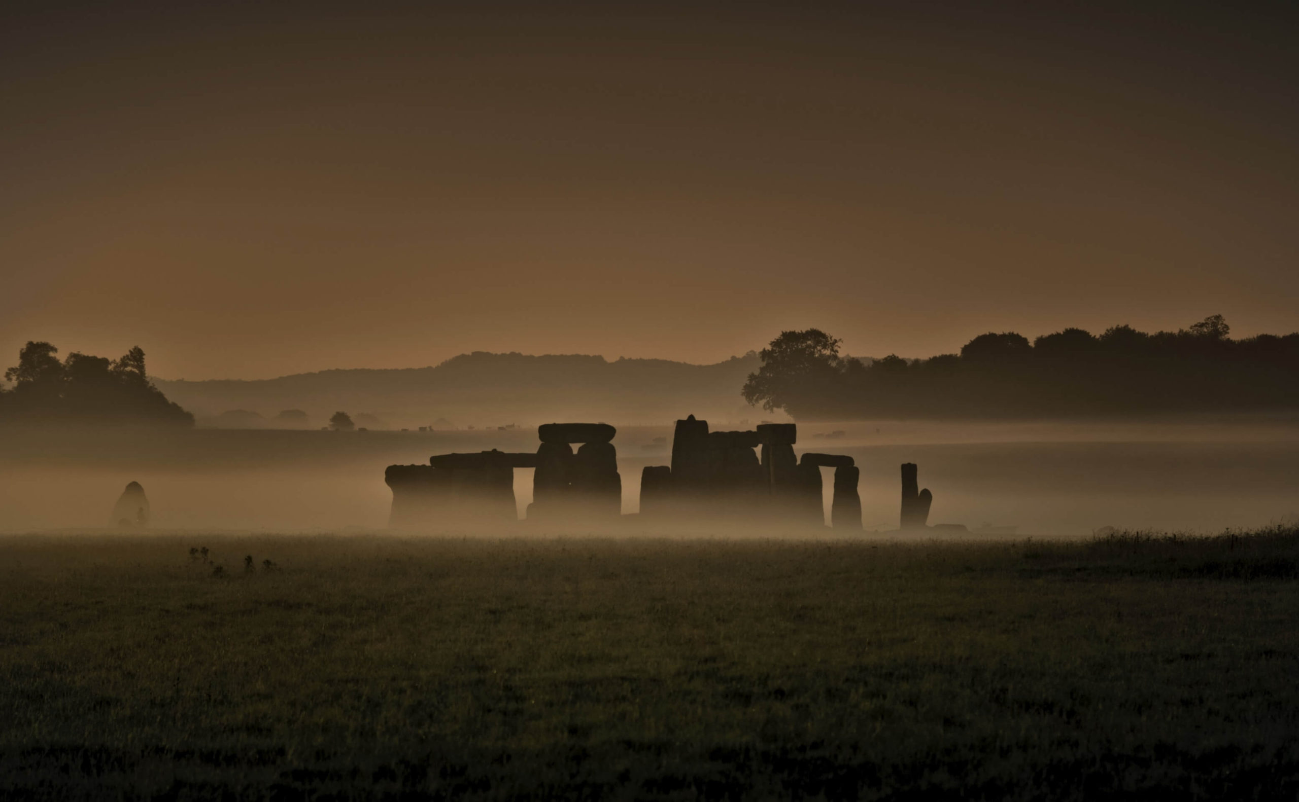Image or Stonehenge circle in golden light, rich with history
