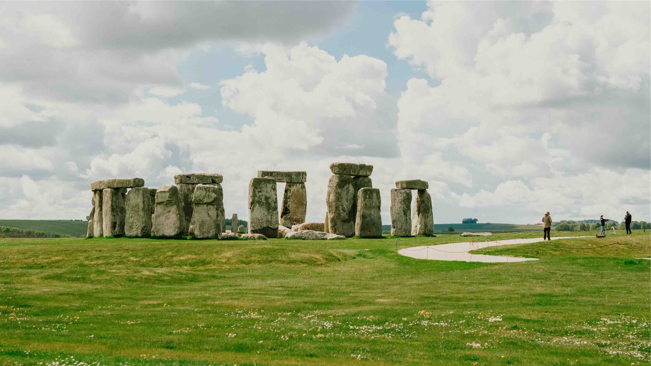 UNESCO site Stonehenge on a cloudy day with minimal people in the frame.