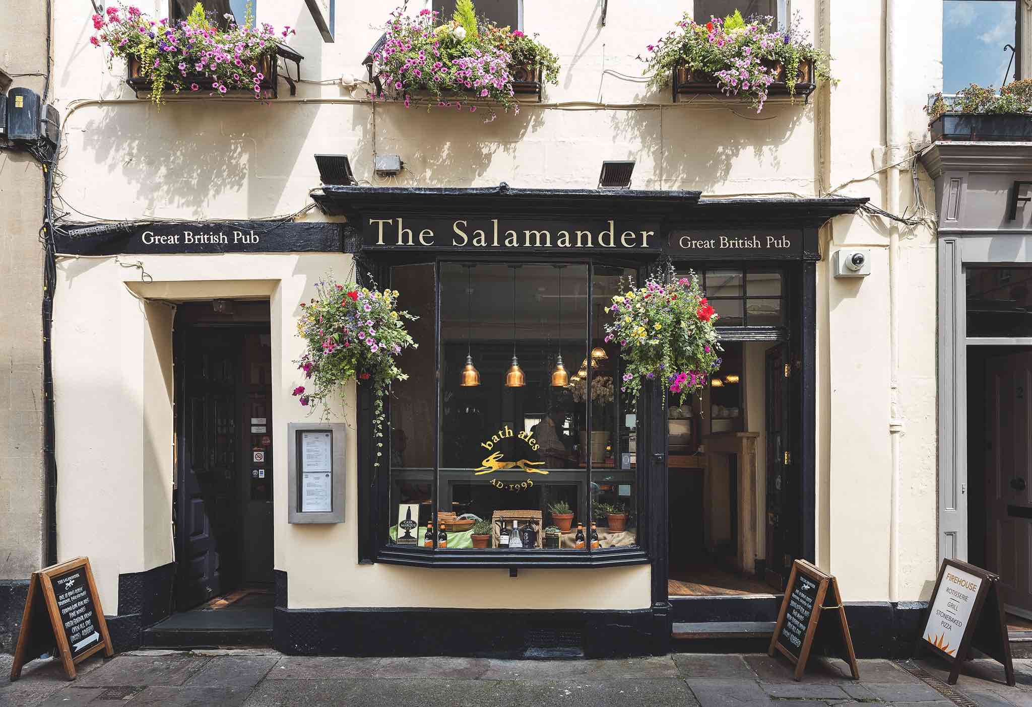 Pub facade in white and black paint rendering. A door is open and sign lettering says "The Salamander. Great British Pub".